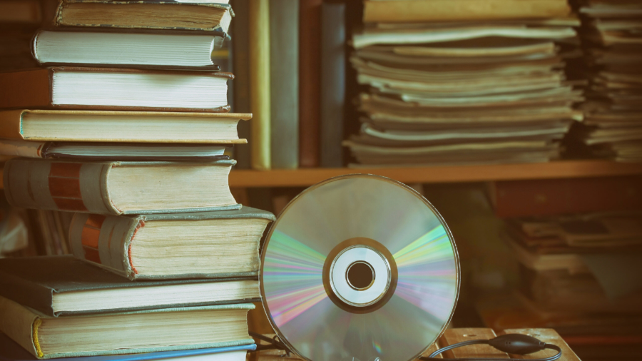 Stack,Of,Books,,Library,,Cd,,Headphones,,Wooden,Table,And,Bookcase