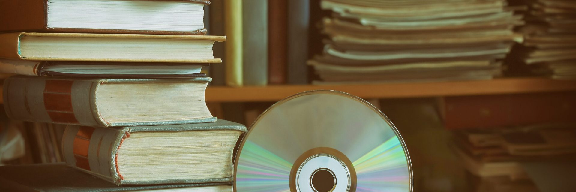 Stack,Of,Books,,Library,,Cd,,Headphones,,Wooden,Table,And,Bookcase